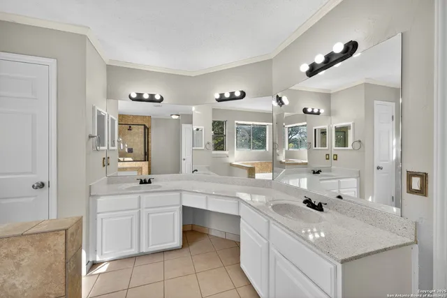 a kitchen with a sink window and cabinets