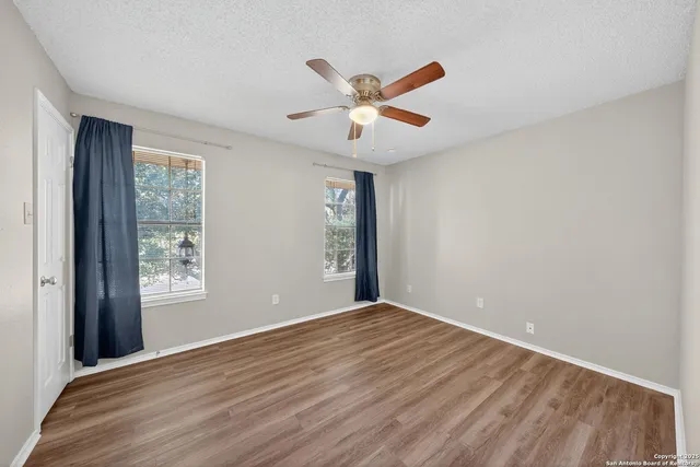 a view of an empty room with window and closet area