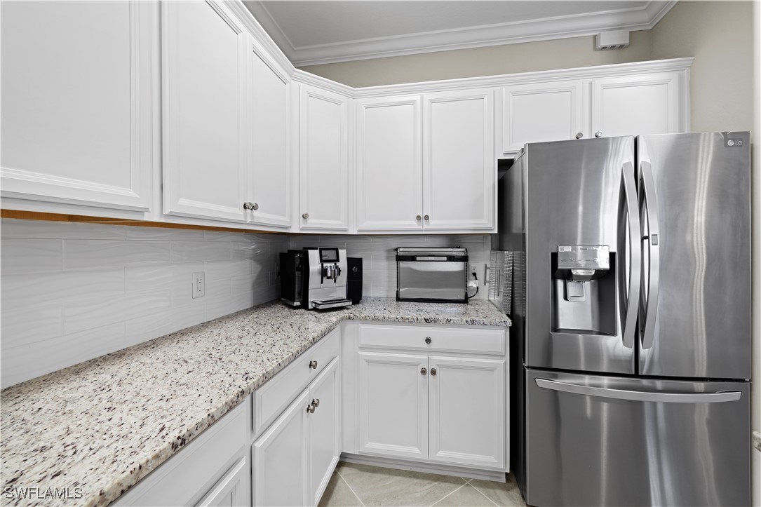 12000 Arbor Trace Drive Fort Myers, FL 33913 - Photo 11 of 50 a kitchen with stainless steel appliances granite countertop a refrigerator sink and cabinets