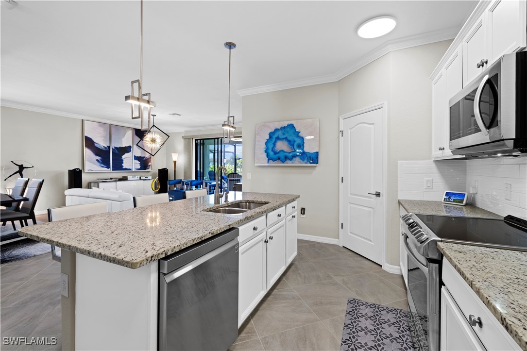 12000 Arbor Trace Drive Fort Myers, FL 33913 - Photo 12 of 50 a kitchen with stainless steel appliances granite countertop a sink a stove and a wooden floor