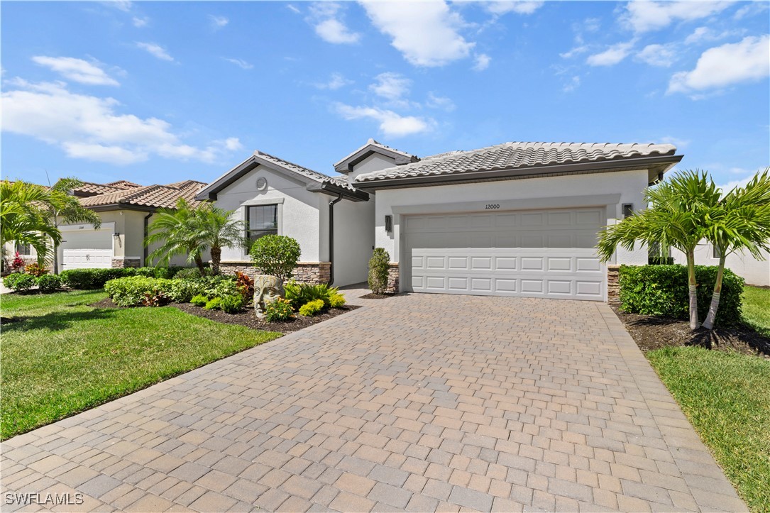 12000 Arbor Trace Drive Fort Myers, FL 33913 - Photo 2 of 50 a front view of a house with garden