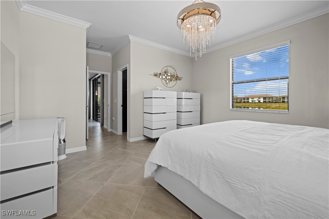 12000 Arbor Trace Drive Fort Myers, FL 33913 - Photo 21 of 50 a spacious bedroom with a bed and a chandelier