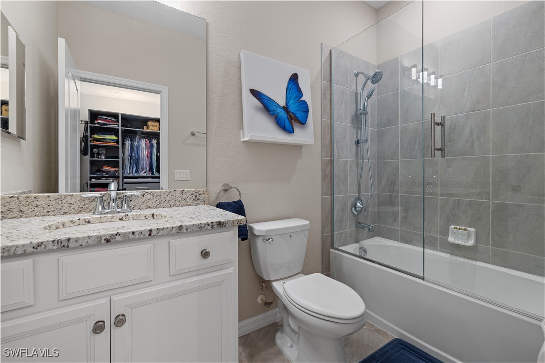 12000 Arbor Trace Drive Fort Myers, FL 33913 - Photo 33 of 50 a bathroom with a granite countertop toilet a sink and a large mirror