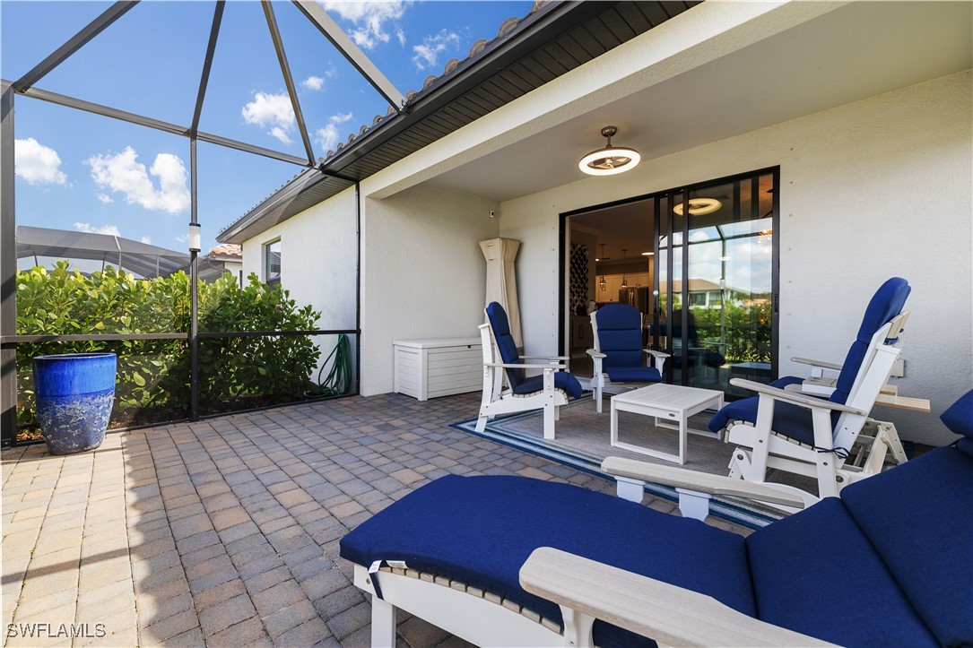 12000 Arbor Trace Drive Fort Myers, FL 33913 - Photo 42 of 50 a view of a patio with table and chairs potted plants with wooden floor