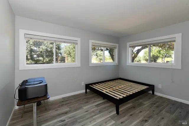a living room with a piano and a window