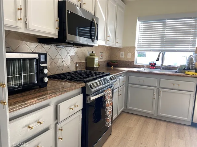a view of a chairs and tables in the back yard of the house