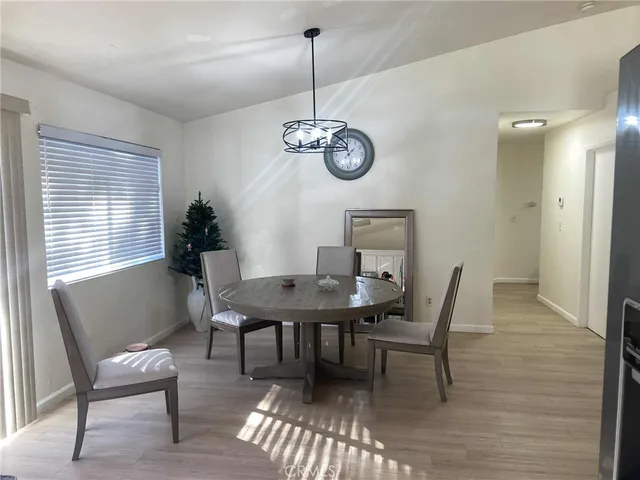 a view of a room with wooden floor and furniture