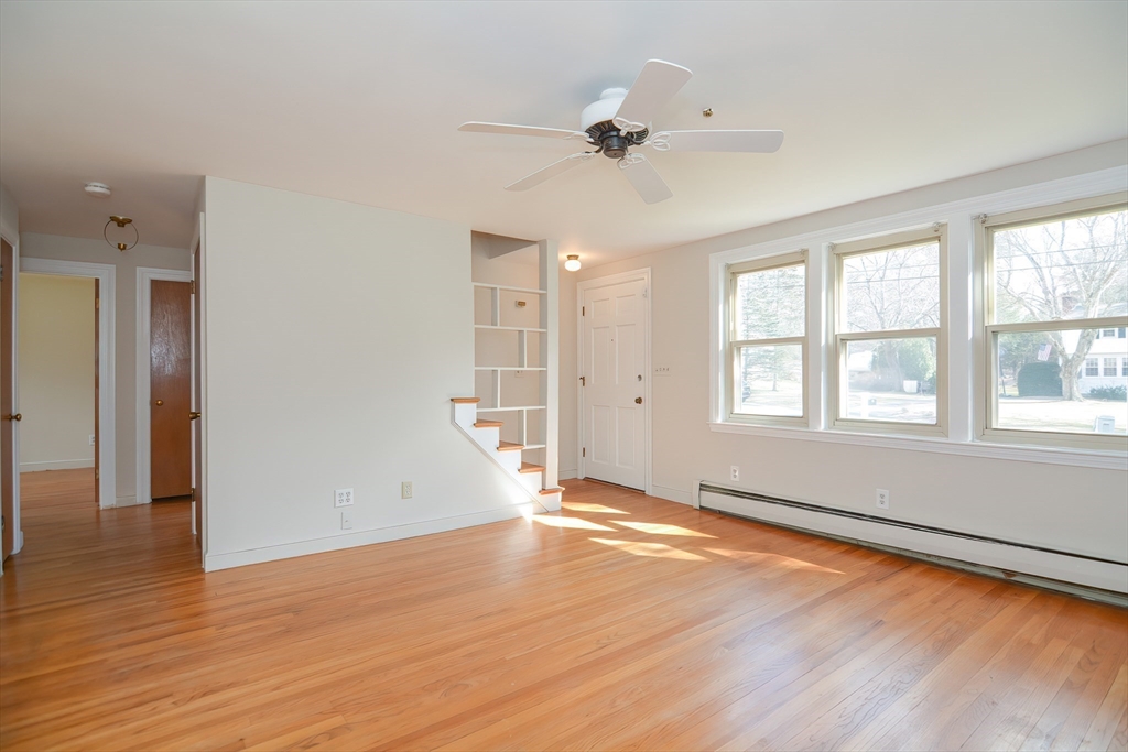 31 Jarr Brook Road Holliston, MA 01746 - Photo 8 of 37 a view of an empty room with wooden floor and a window
