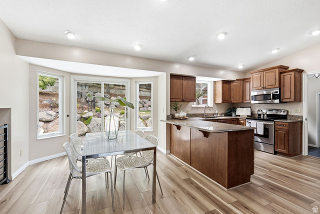 11875 South Elm Ridge Road Sandy, UT 84094 - Photo 10 of 53 Open-concept kitchen and dining area featuring wood-finish flooring, recessed lighting, and a bay window