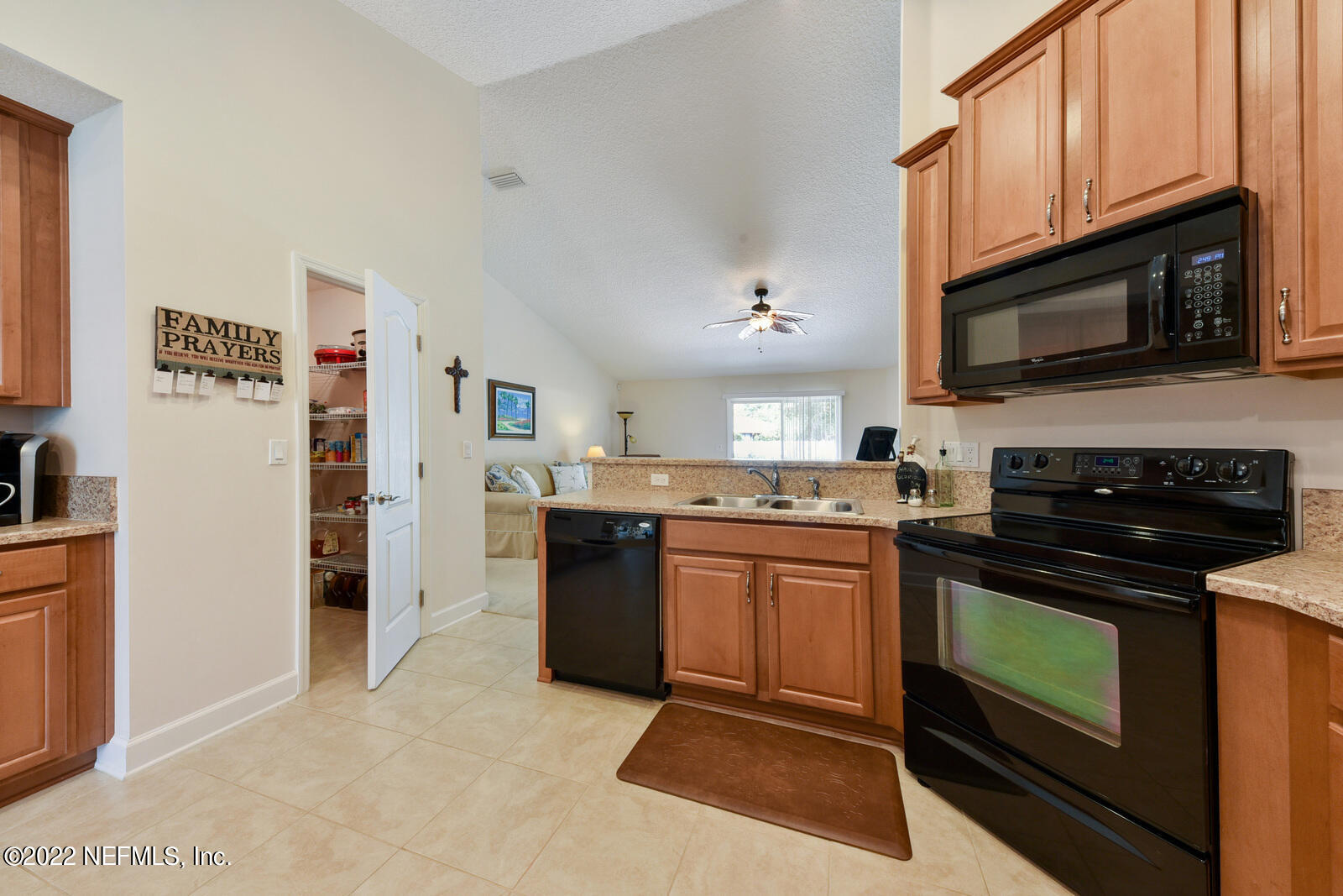 1973 Derringer Road Jacksonville, FL 32225 - Photo 13 of 25 a kitchen with stainless steel appliances granite countertop a stove top oven microwave and refrigerator