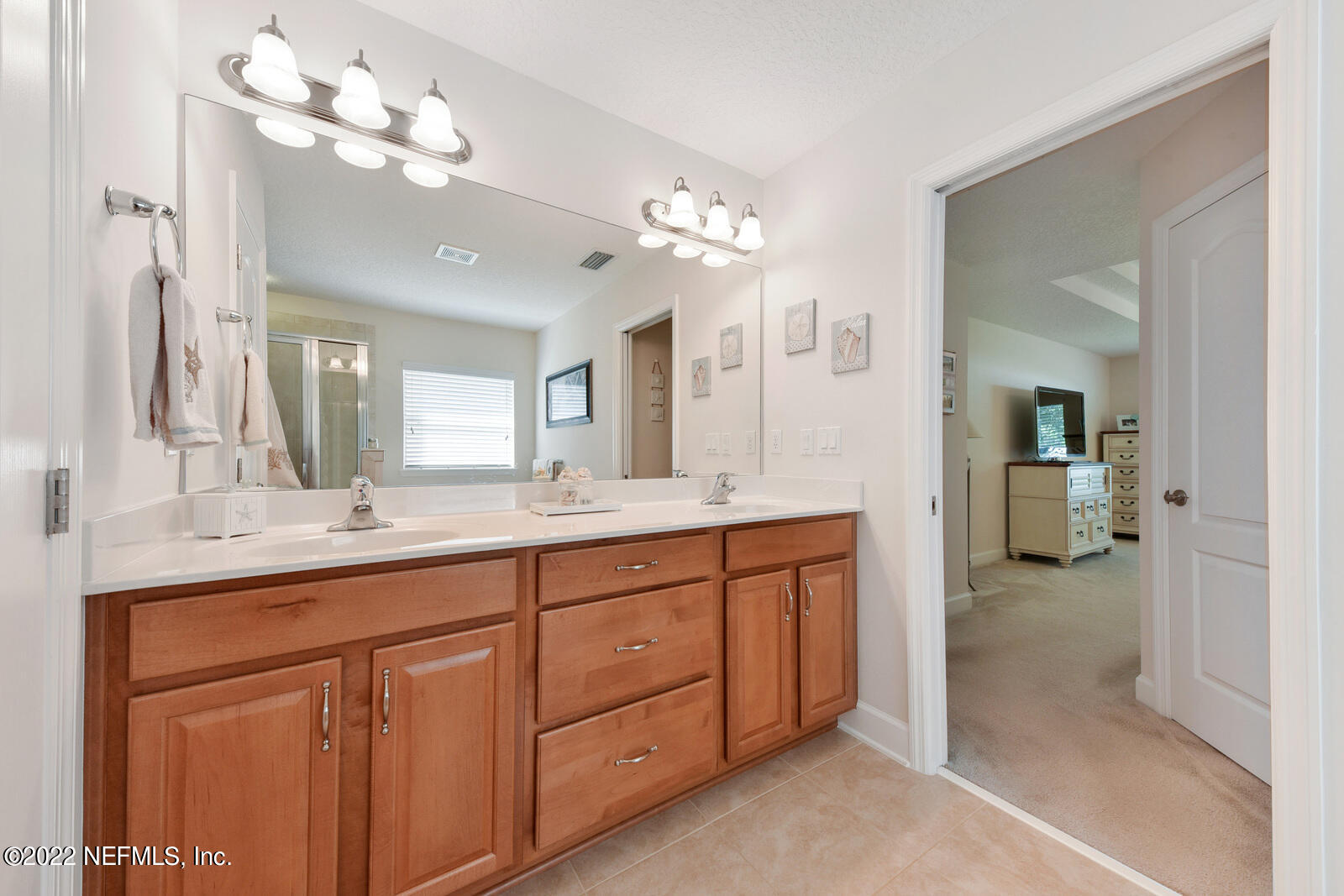1973 Derringer Road Jacksonville, FL 32225 - Photo 16 of 25 a bathroom with a double vanity sink and a mirror