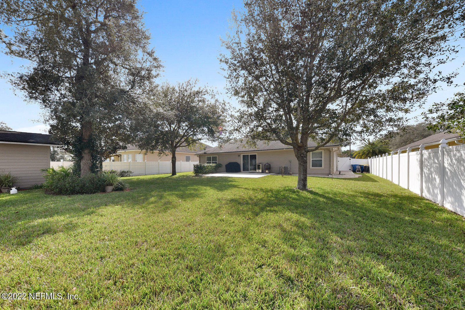 1973 Derringer Road Jacksonville, FL 32225 - Photo 25 of 25 a view of a house with a big yard and large trees