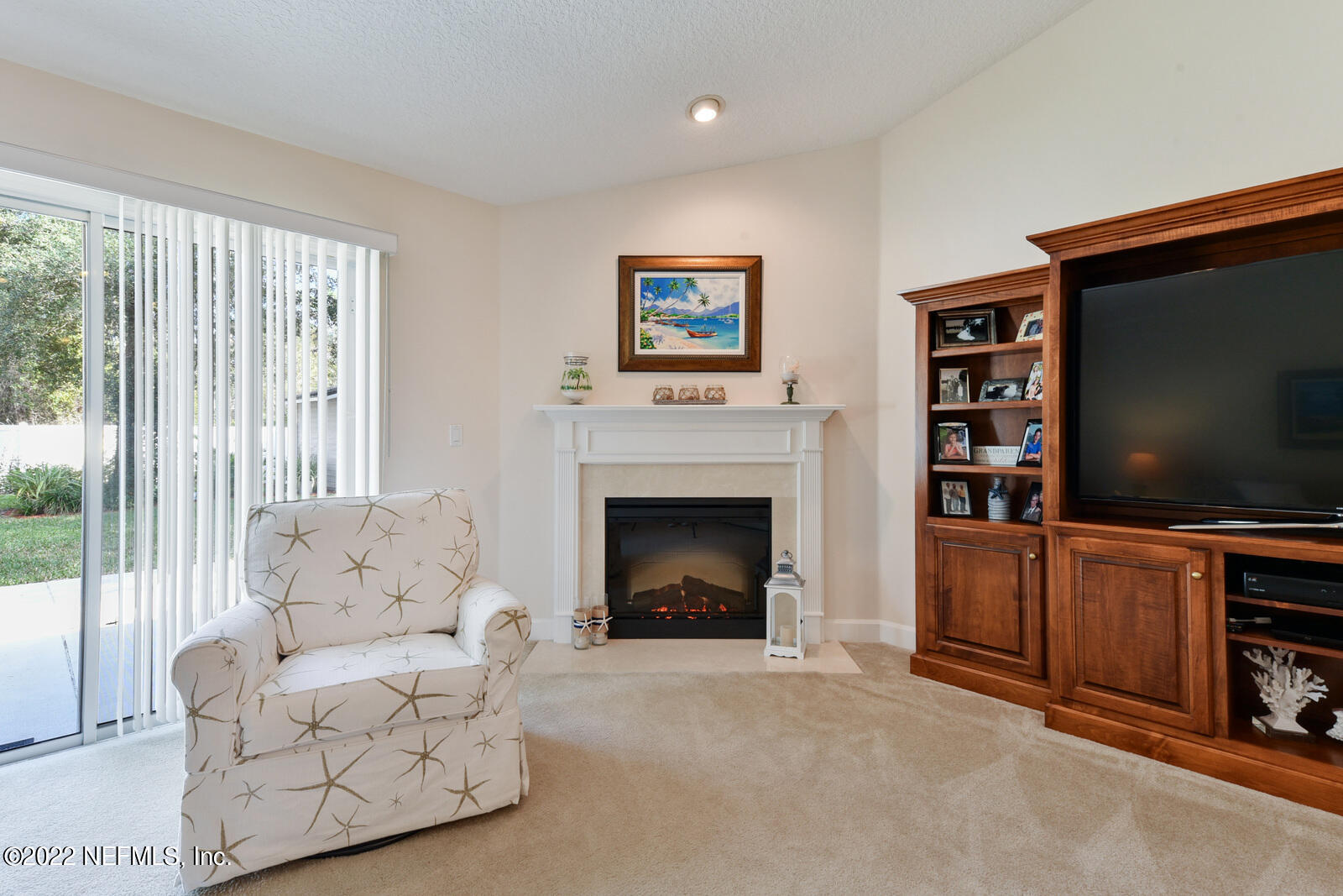 1973 Derringer Road Jacksonville, FL 32225 - Photo 8 of 25 a living room with furniture a flat screen tv and a fireplace