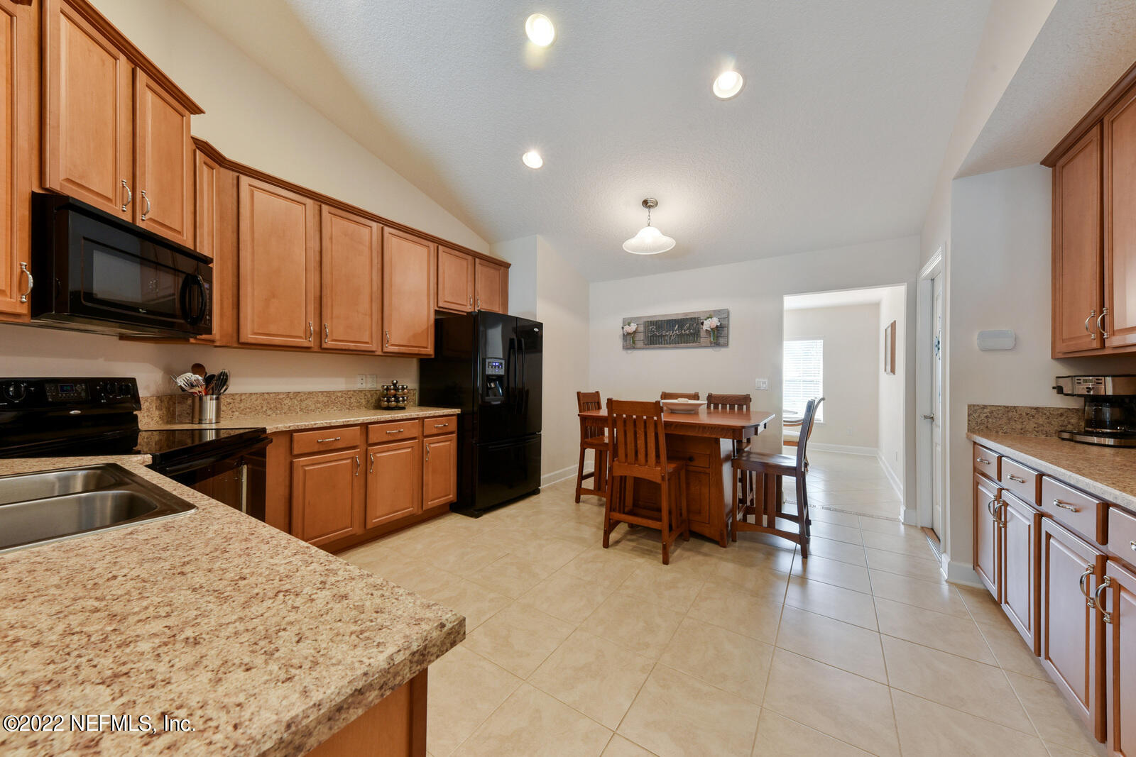 1973 Derringer Road Jacksonville, FL 32225 - Photo 10 of 25 a kitchen with stainless steel appliances granite countertop a refrigerator stove microwave and sink