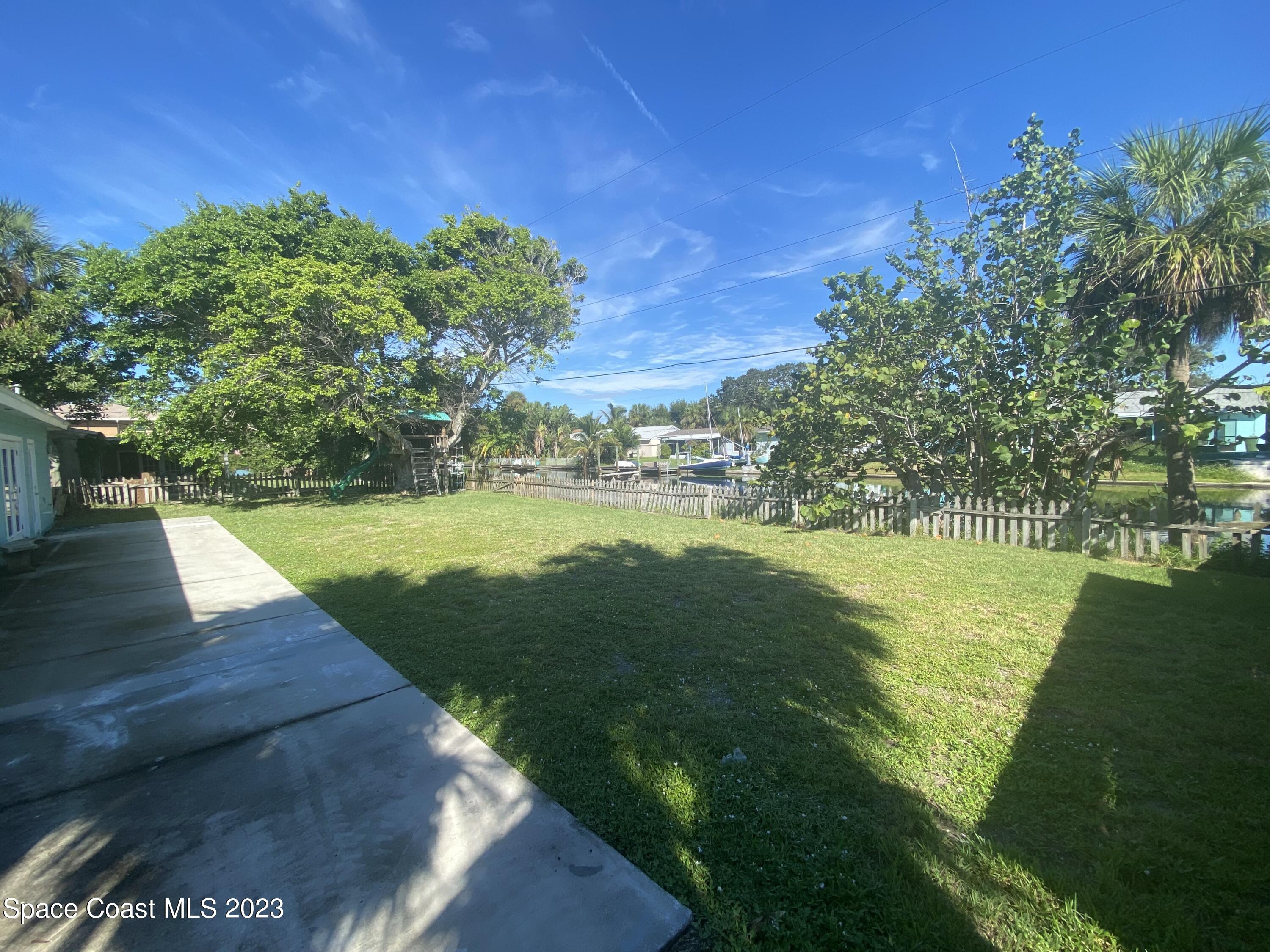 433 Blakey Boulevard Cocoa Beach, FL 32931 - Photo 11 of 15 a view of a lake with a big yard