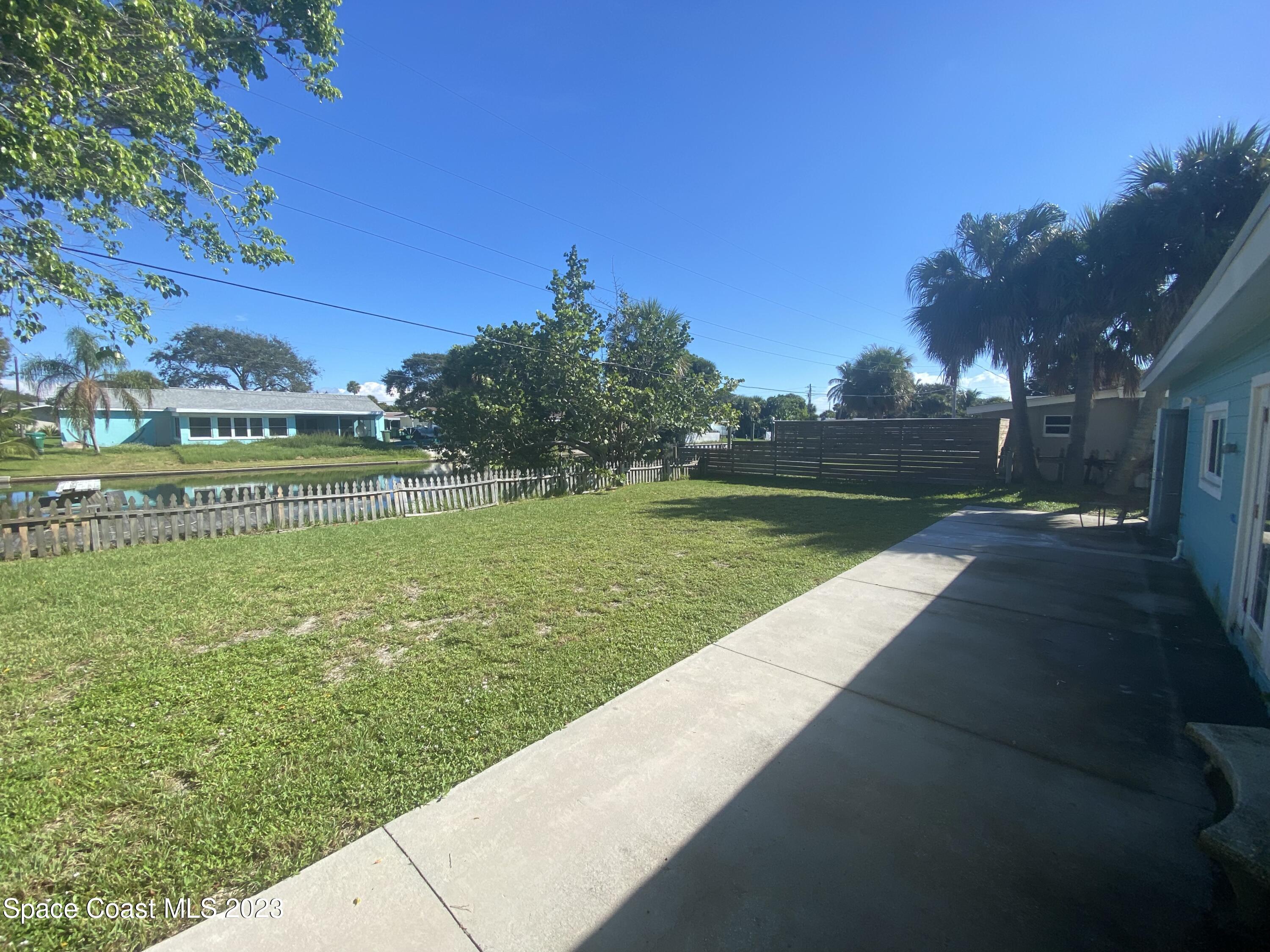 433 Blakey Boulevard Cocoa Beach, FL 32931 - Photo 13 of 15 a view of a garden from a bench