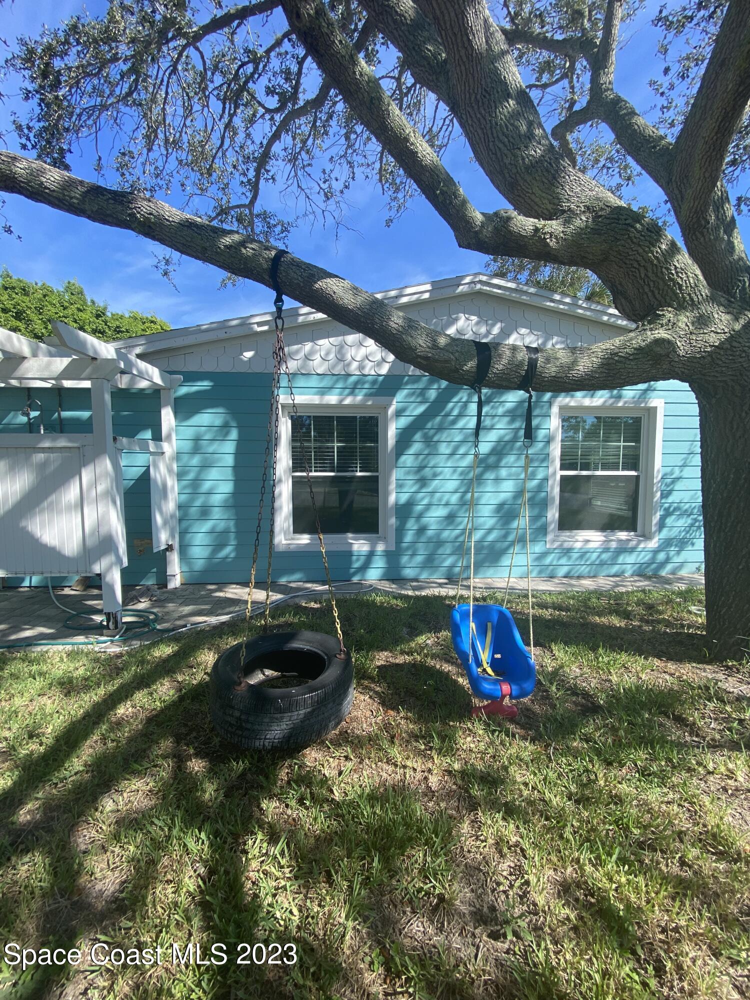 433 Blakey Boulevard Cocoa Beach, FL 32931 - Photo 2 of 15 a backyard of a house with portable swimming pool and outdoor seating