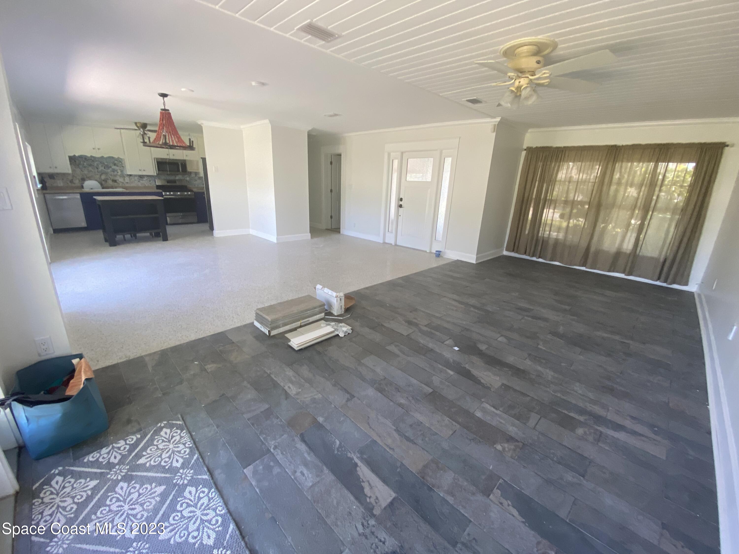 433 Blakey Boulevard Cocoa Beach, FL 32931 - Photo 4 of 15 a view of livingroom and dining room with wooden floor