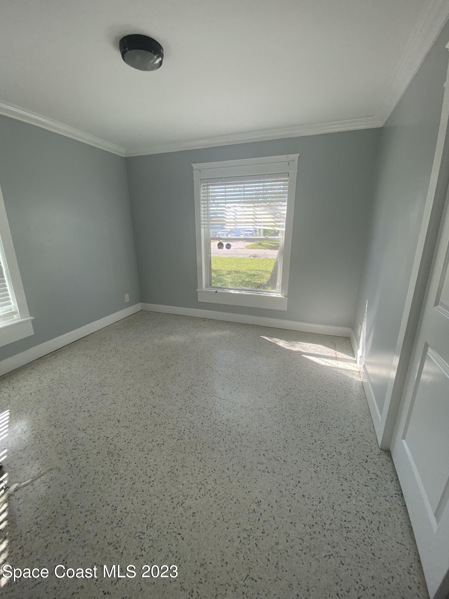 433 Blakey Boulevard Cocoa Beach, FL 32931 - Photo 9 of 15 an empty room with a window