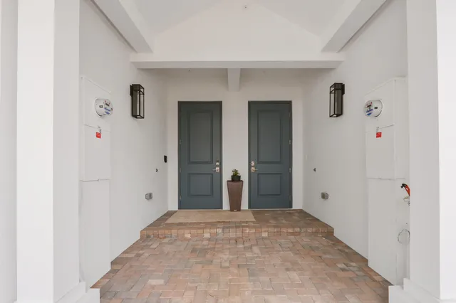 a living room with furniture kitchen and a large window