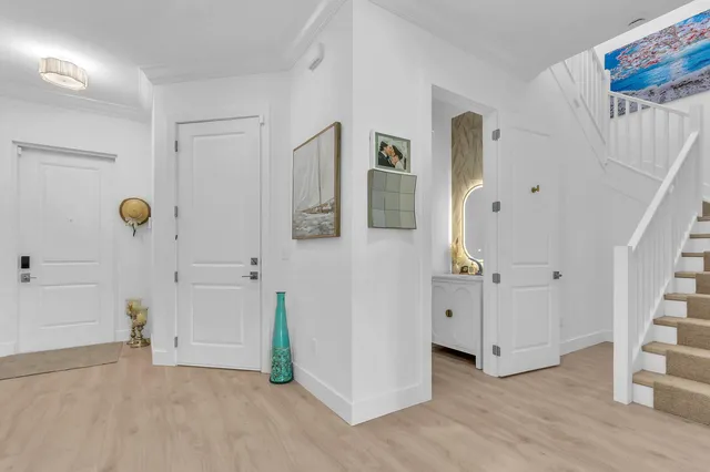 a living room with furniture and a view of kitchen