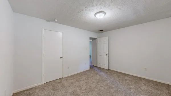a view of an empty room and closet