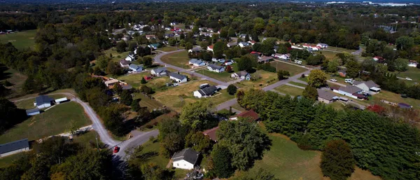 an aerial view of a house with a yard and trees