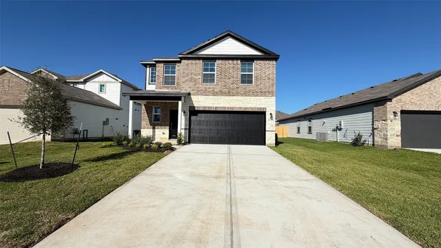 a front view of a house with garage