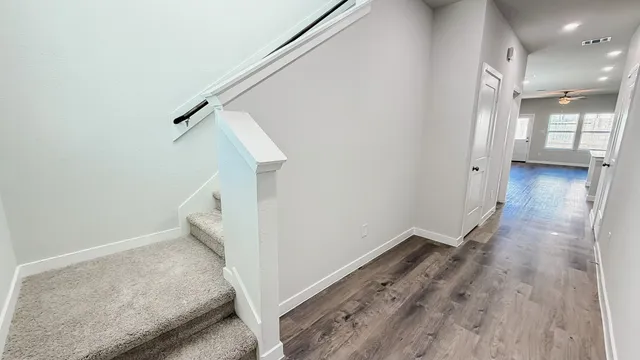 a view of a hallway view with staircase