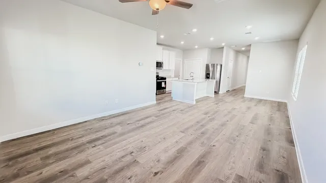 a view of a kitchen with wooden floor and a sink