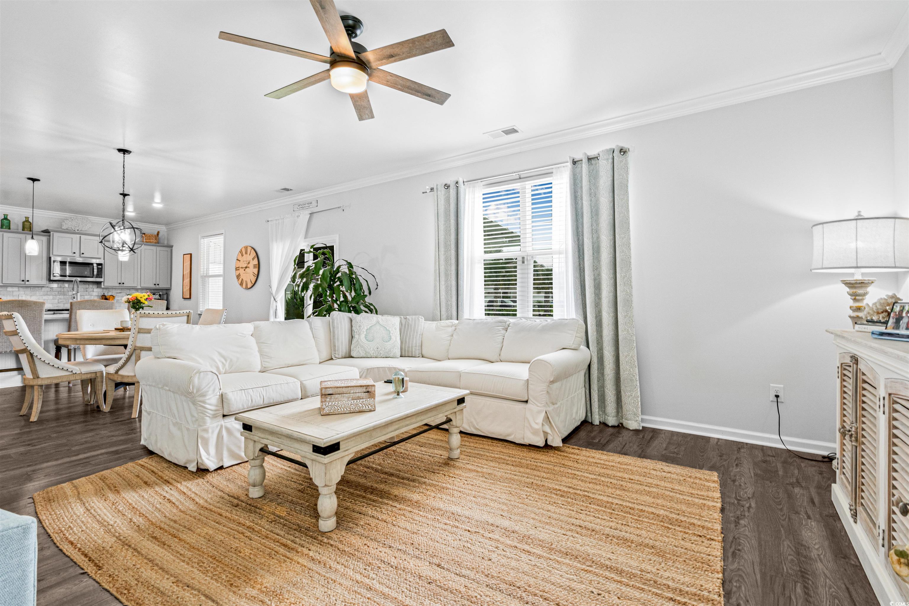 331 Emery Oak Drive Murrells Inlet, SC 29576 - Photo 15 of 32 Living room with crown molding and lots of natural light.