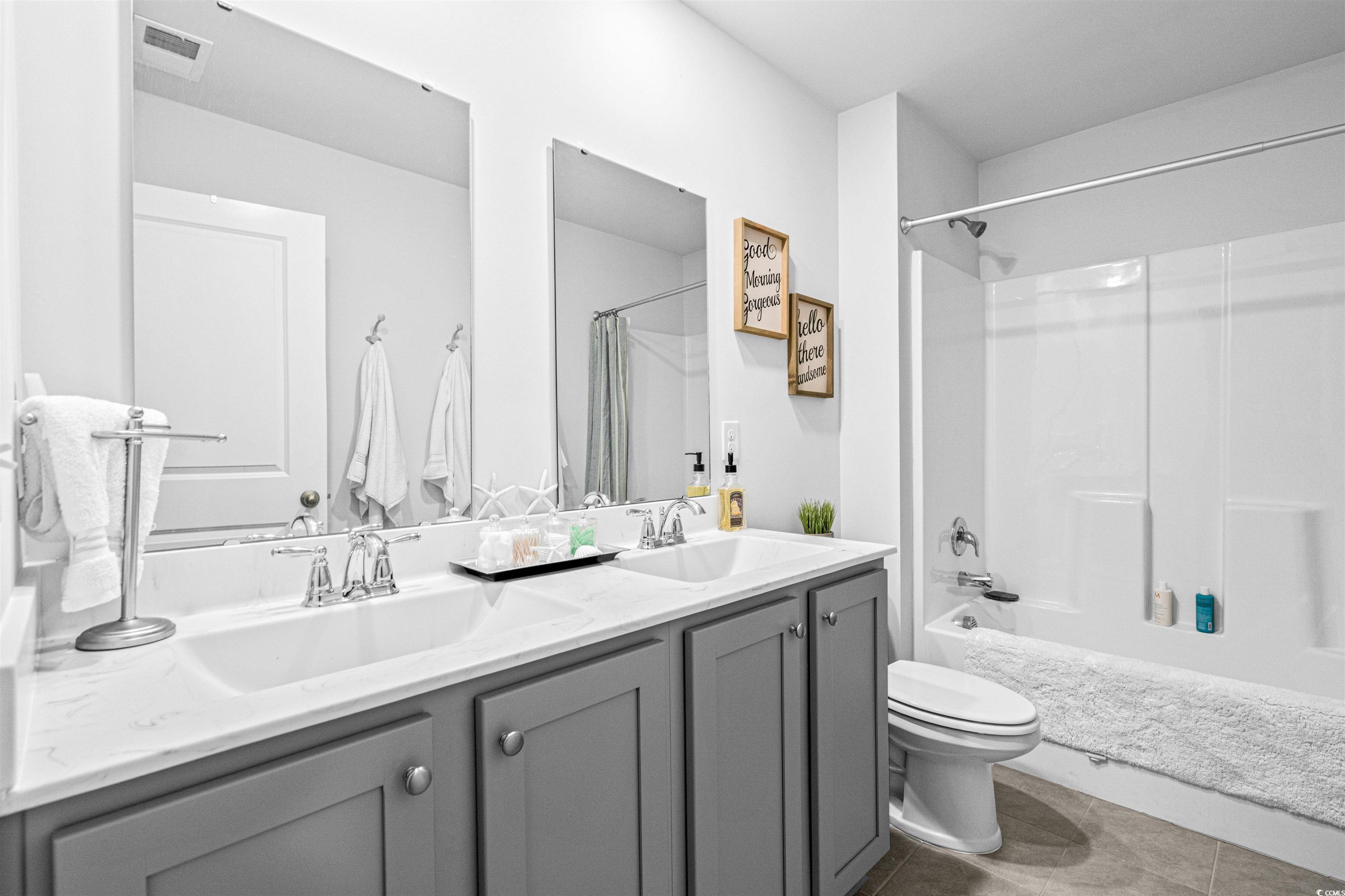 331 Emery Oak Drive Murrells Inlet, SC 29576 - Photo 25 of 32 Second floor guest bathroom with double bowl sinks and tub/shower combination.
