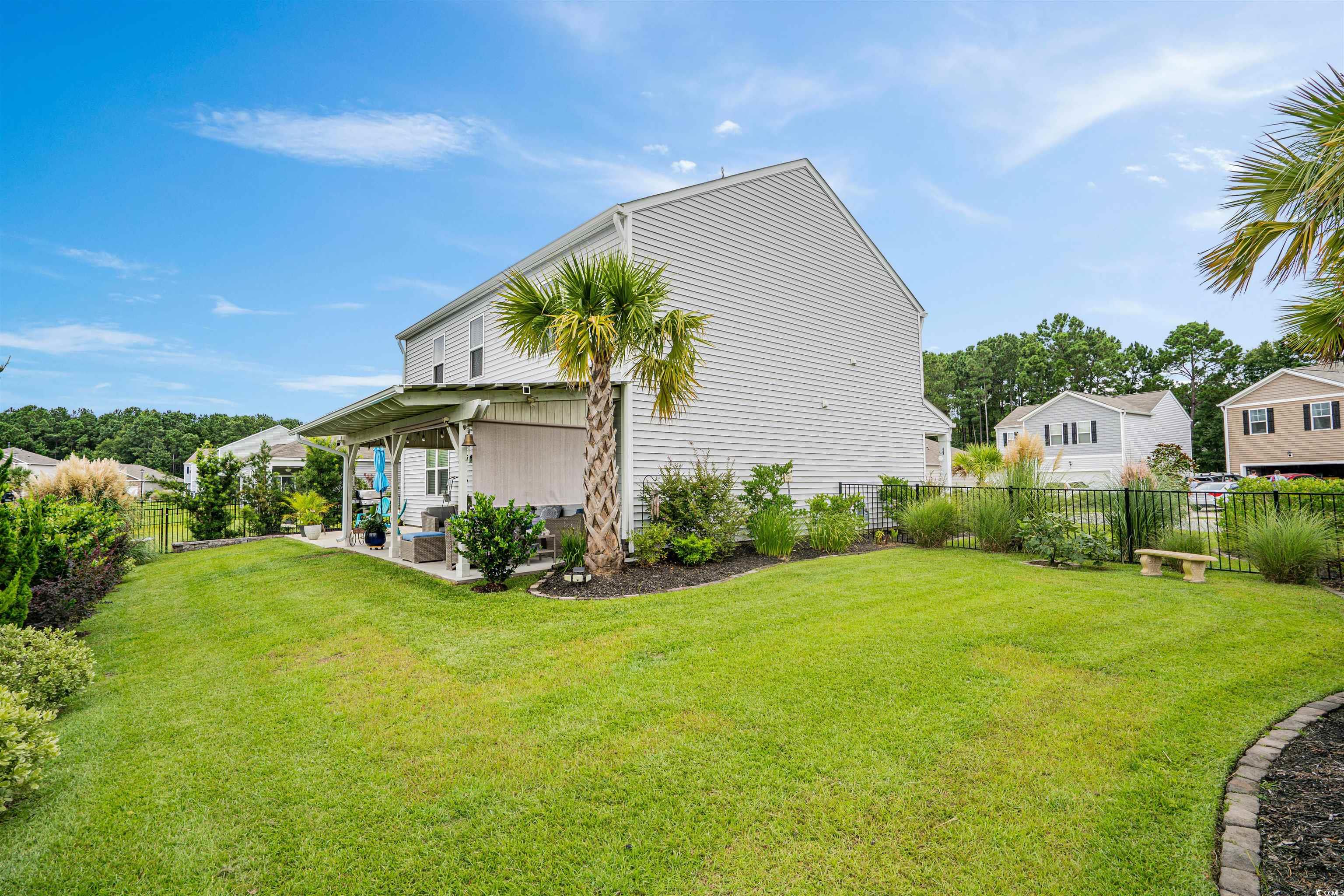 331 Emery Oak Drive Murrells Inlet, SC 29576 - Photo 28 of 32 Fenced yard accented by an expansive landscaping including palm trees and juniper bushes. The yard has an irrigation system.