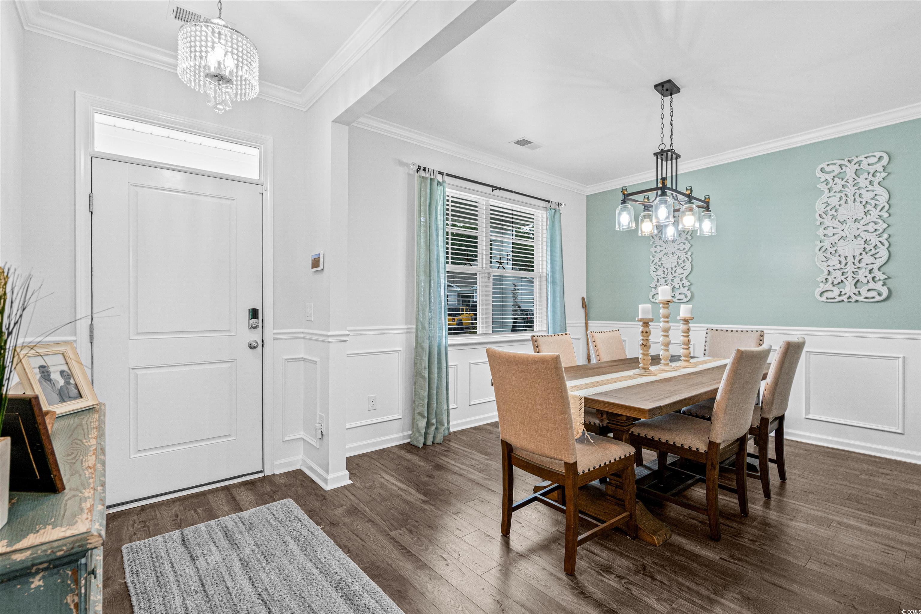 331 Emery Oak Drive Murrells Inlet, SC 29576 - Photo 4 of 32 Large dining room featuring a modern chandelier, plenty of natural light and ornamental molding.