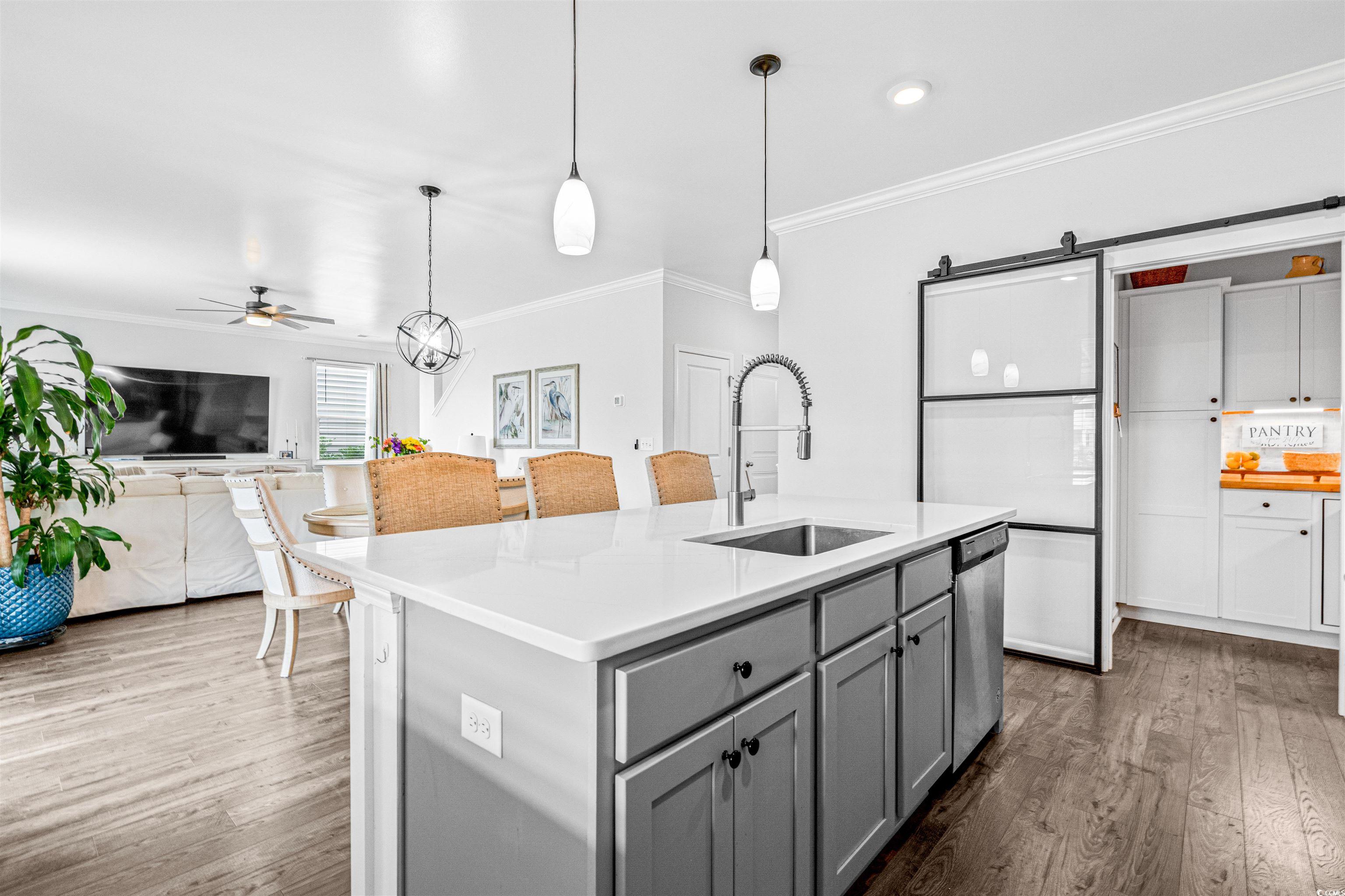 331 Emery Oak Drive Murrells Inlet, SC 29576 - Photo 6 of 32 Kitchen featuring gray cabinetry, a kitchen island with breakfast bar area.