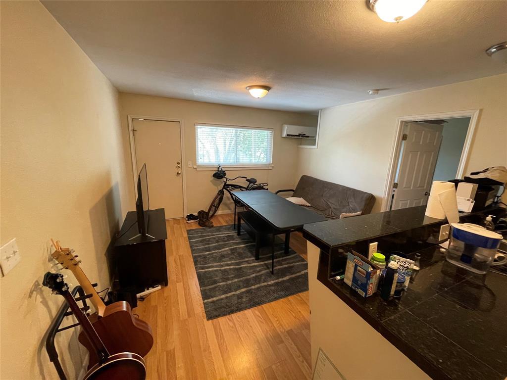 304 East 33rd Street, Unit 20 Austin, TX 78705 - Photo 4 of 12 a living room with furniture and wooden floor