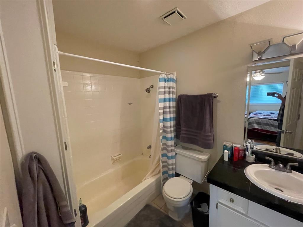 304 East 33rd Street, Unit 20 Austin, TX 78705 - Photo 5 of 12 a bathroom with a granite countertop sink toilet mirror and shower