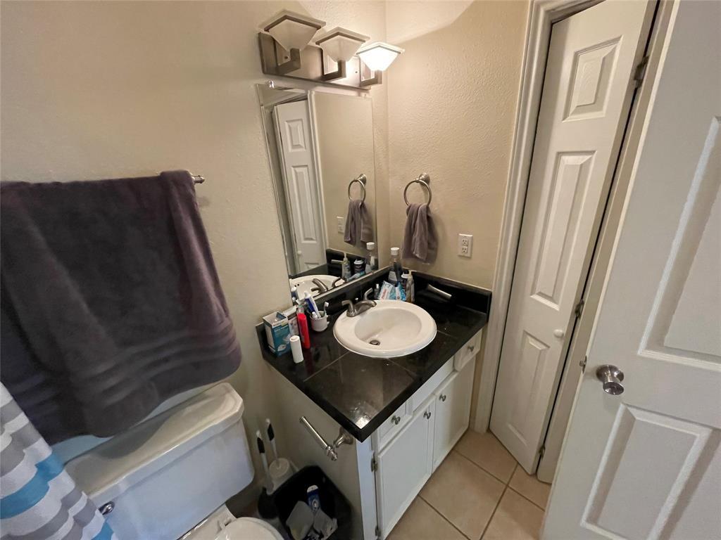 304 East 33rd Street, Unit 20 Austin, TX 78705 - Photo 6 of 12 a bathroom with a sink vanity granite and a mirror