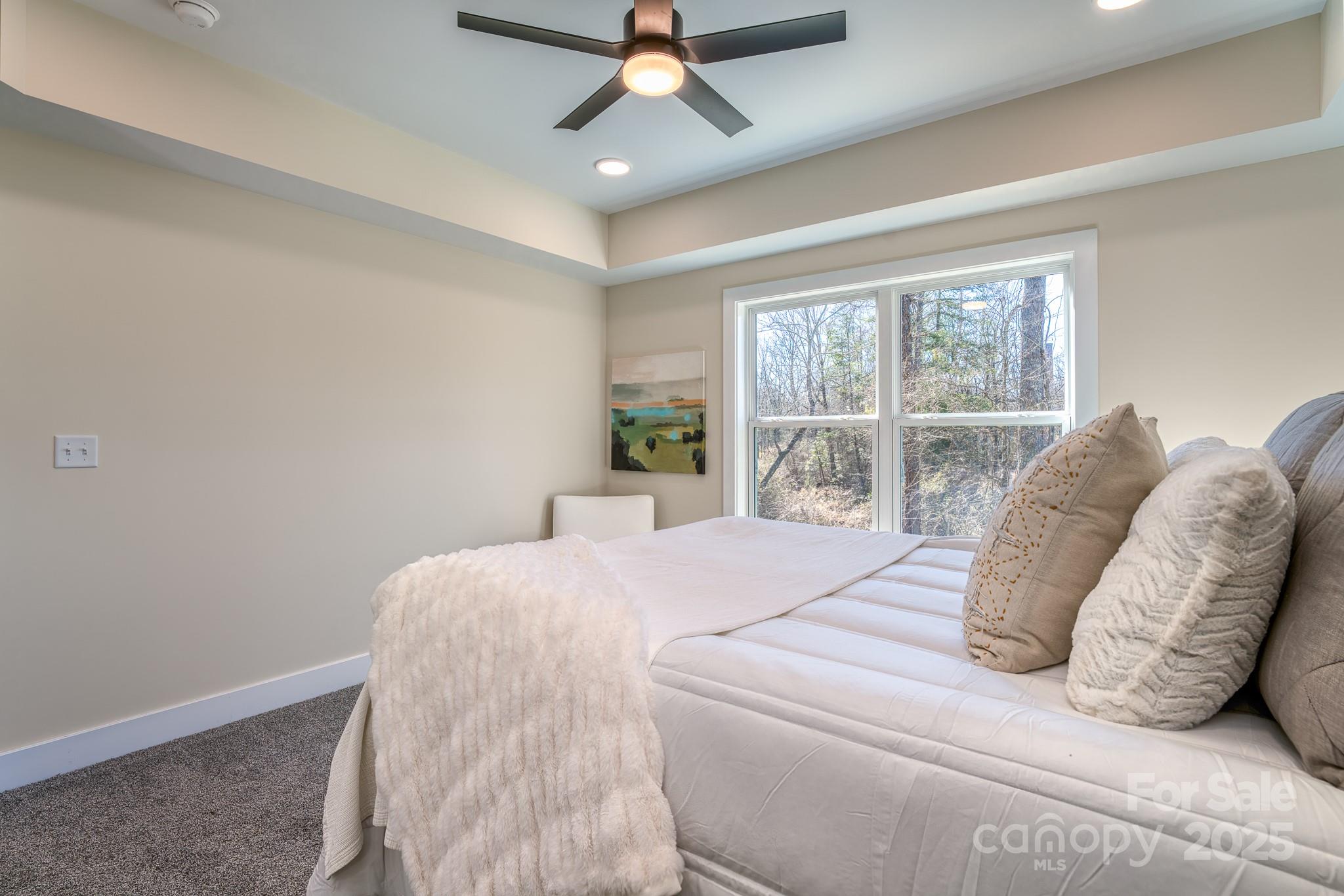 143 Carver Street, Unit 7 Brevard, NC 28712 - Photo 19 of 28 a bed sitting in a bedroom next to a window
