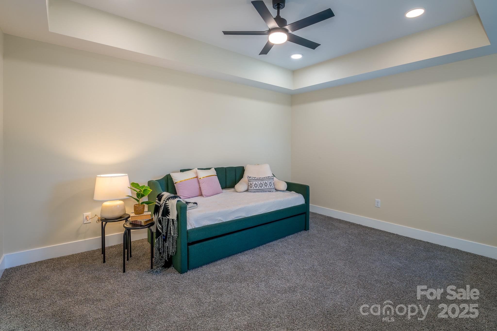143 Carver Street, Unit 7 Brevard, NC 28712 - Photo 22 of 28 a bedroom with a bed and a ceiling fan