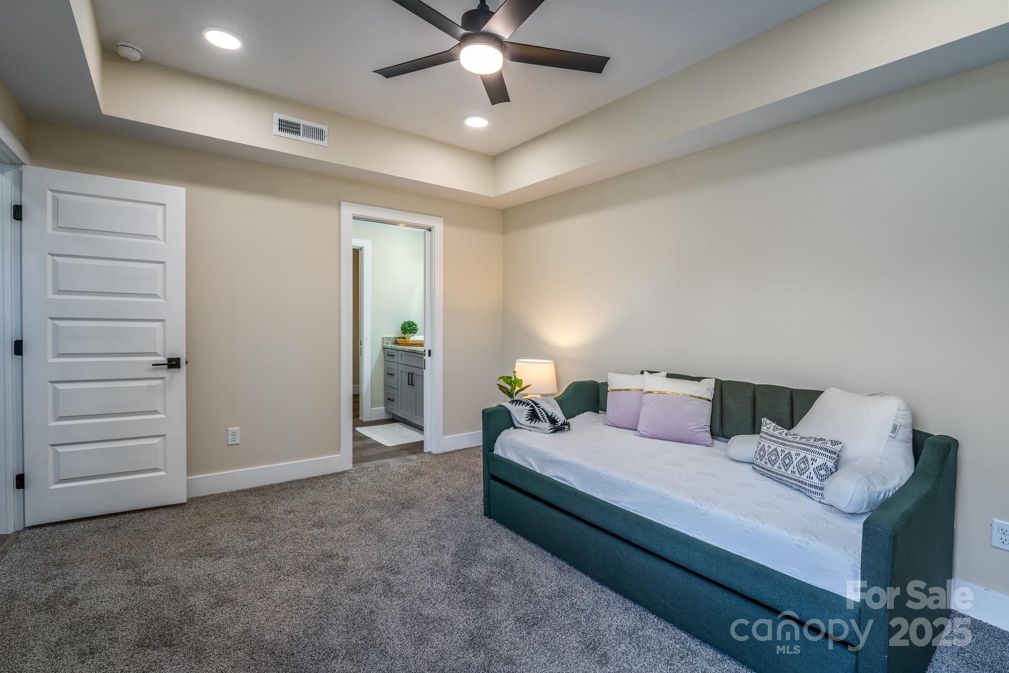 143 Carver Street, Unit 7 Brevard, NC 28712 - Photo 23 of 28 a bedroom with a bed and a ceiling fan