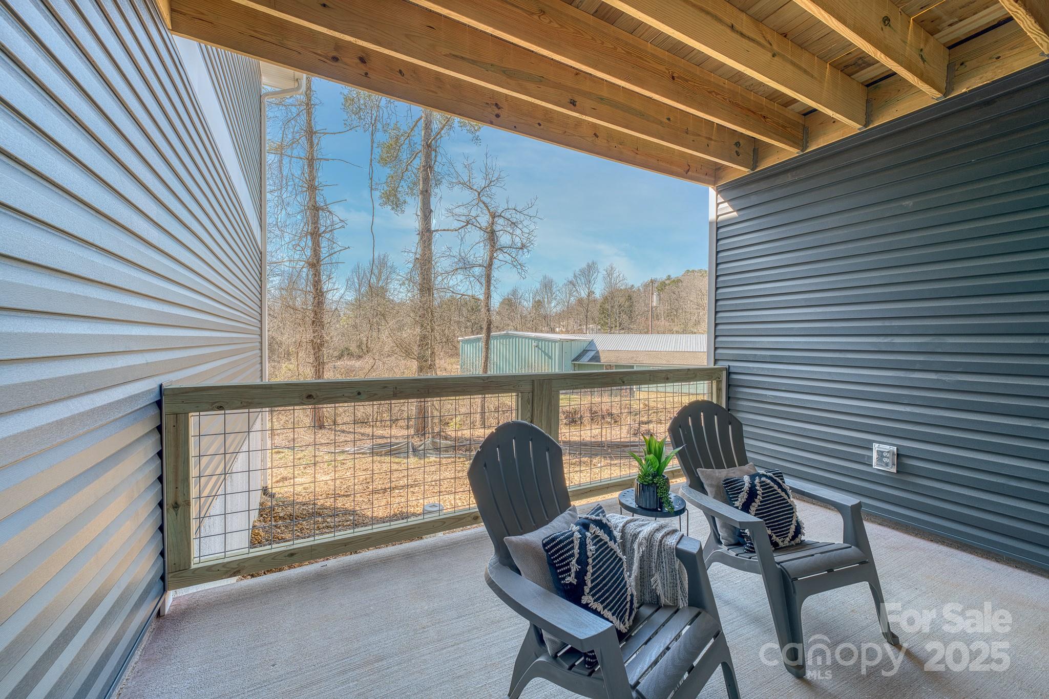 143 Carver Street, Unit 7 Brevard, NC 28712 - Photo 25 of 28 a view of a chairs and table in the balcony