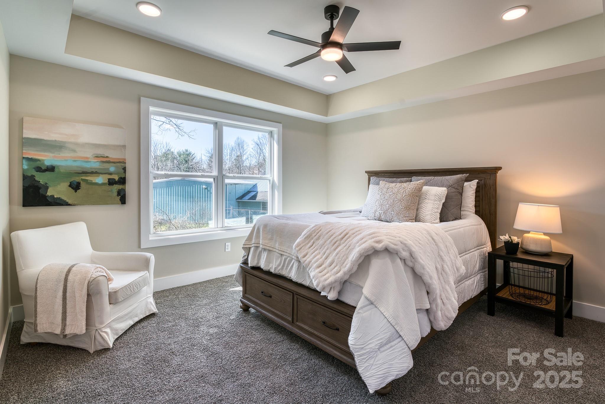 143 Carver Street, Unit 7 Brevard, NC 28712 - Photo 6 of 28 a spacious bedroom with a bed and a couch