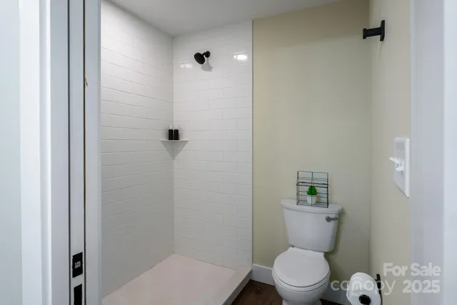 a white toilet sitting next to a bathroom sink