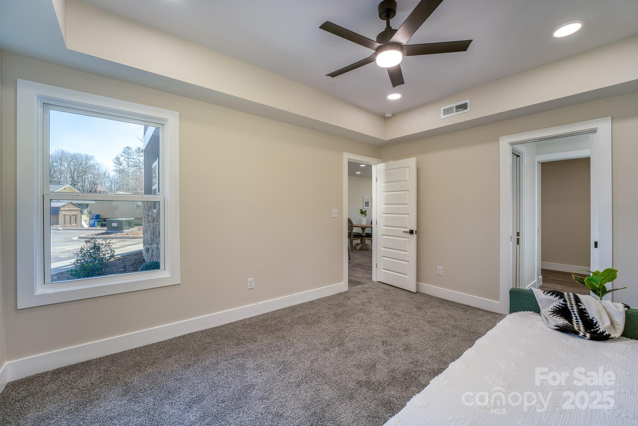143 Carver Street, Unit 7 Brevard, NC 28712 - Photo 9 of 28 a view of an empty room with window and a ceiling fan
