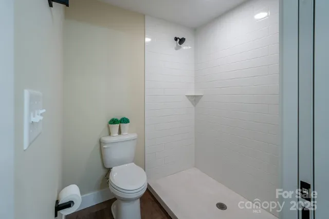 a white toilet sitting next to a bathroom sink and tub