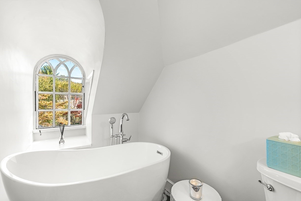 2 Phillips Pond Road, Unit 2 Natick, MA 01760 - Photo 28 of 35 a white bath tub sitting next to a window