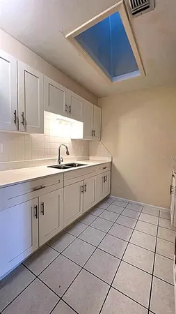 a kitchen with a sink and cabinets