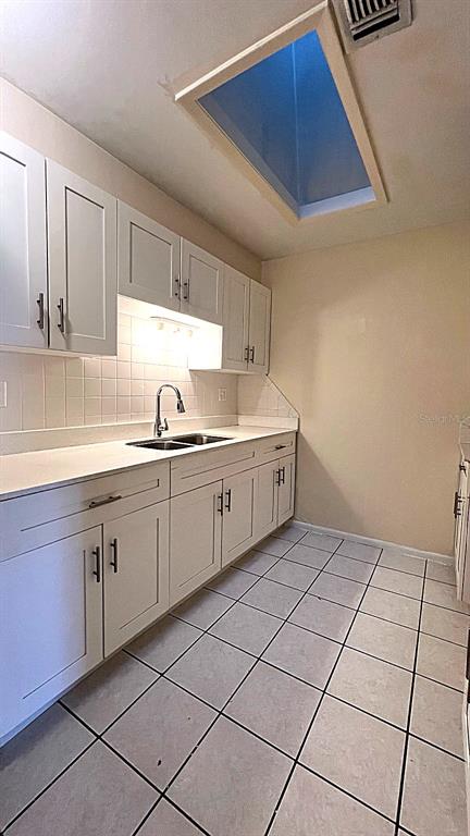 4166 Flying Fortress Avenue Kissimmee, FL 34741 - Photo 3 of 14 a kitchen with a sink and cabinets