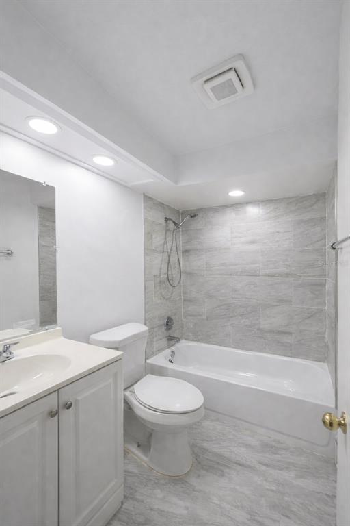 4166 Flying Fortress Avenue Kissimmee, FL 34741 - Photo 4 of 14 a bathroom with a toilet a sink and a mirror